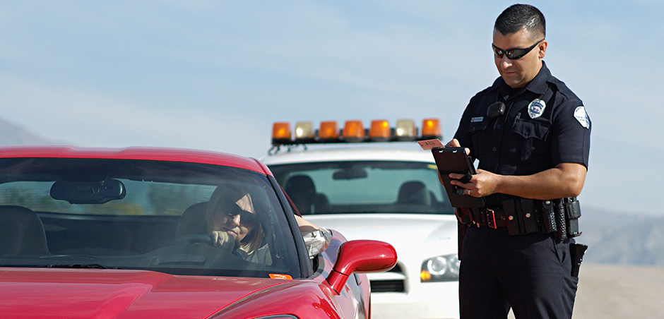 Officer giving ticket to a driver