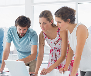 employees looking at a laptop